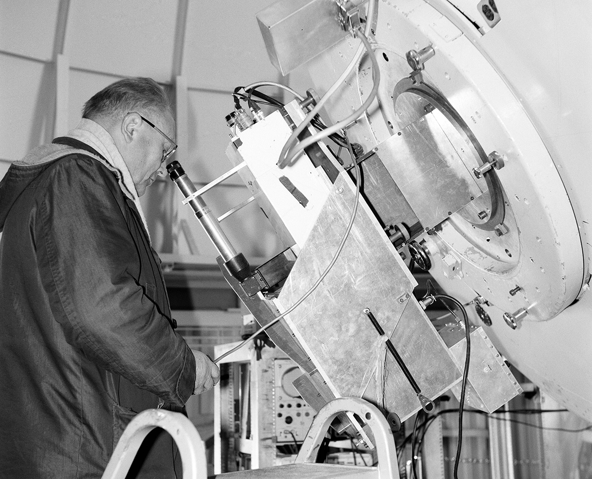 Black and white photo of kuiper looking into spectrometer