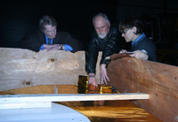 The author (center) goes over the New Horizons model with Smithsonian National Air and Space Museum staff. 